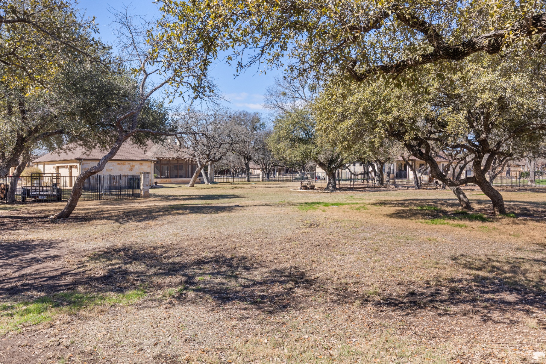 One acre backyard with mature oak tree canopy and privacy fencing