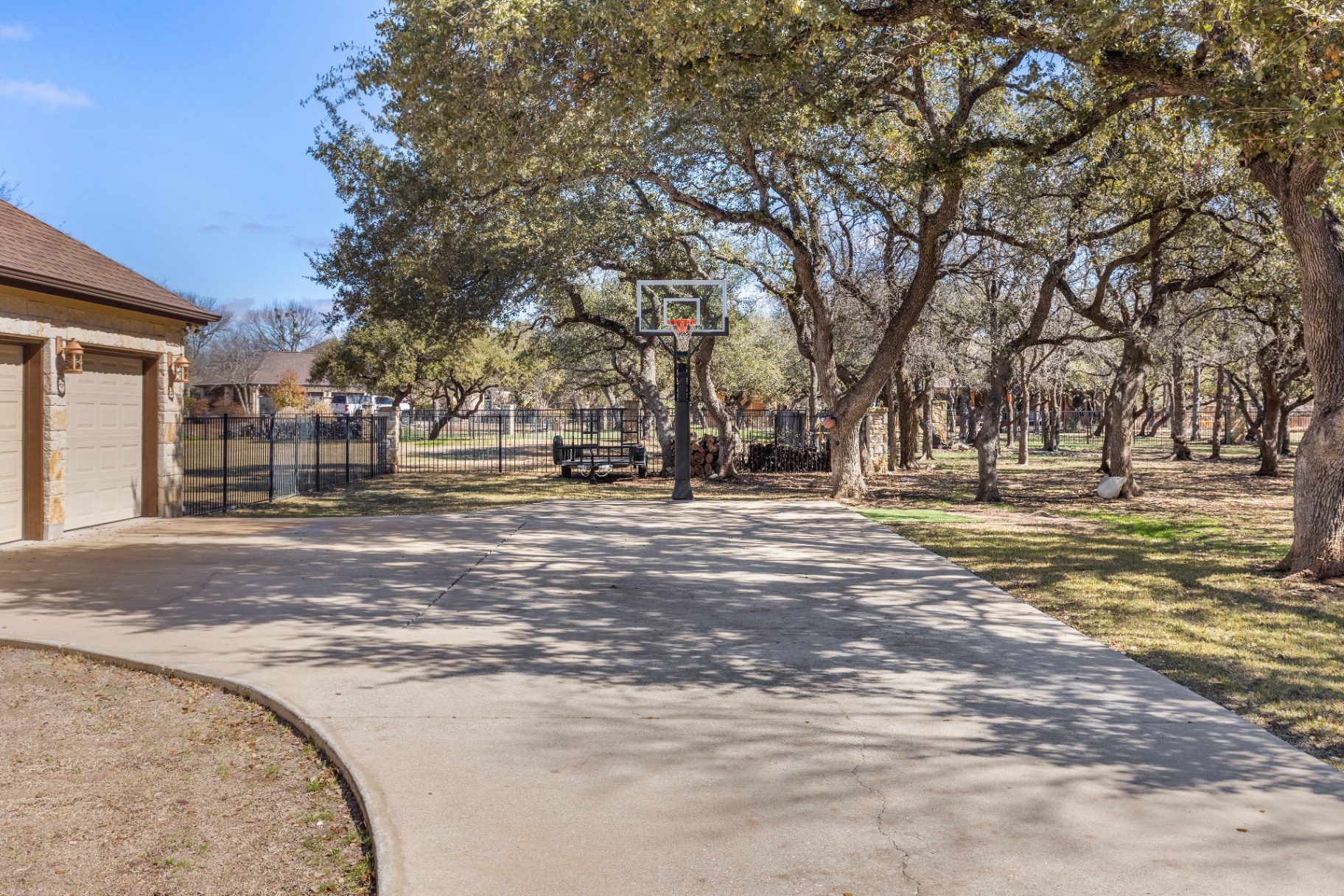 Driveway and mature oak trees with basketball hoop