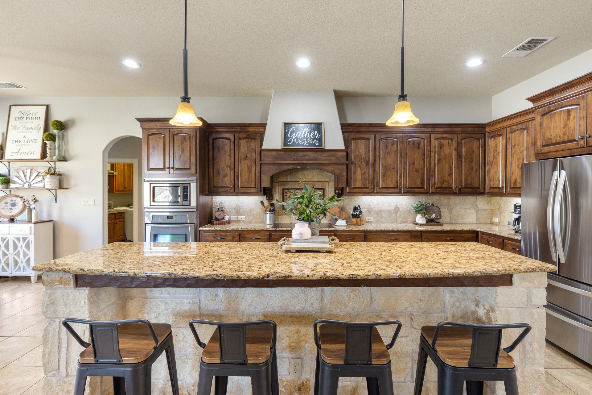 Large granite kitchen island with seating and custom cabinetry