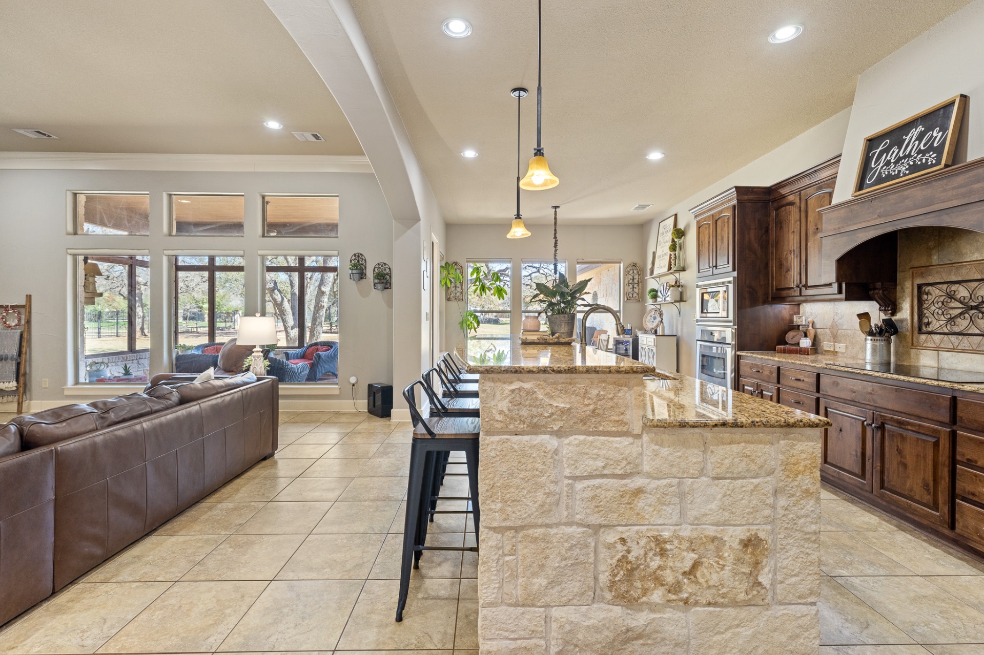 Open floor plan view from kitchen island to living area and screened patio